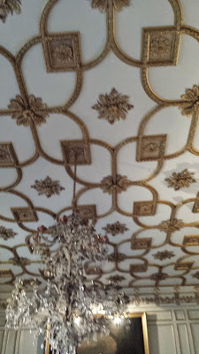 ceiling with metal gingerbread and large chancelier